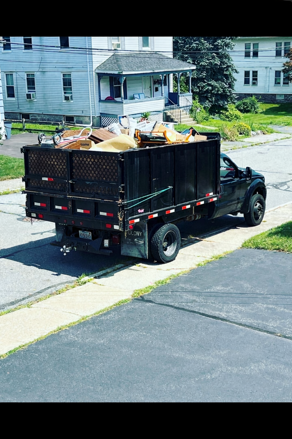 CJ Junk Removal truck loaded with junk